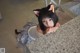 A woman in a cat ears headband leaning on a counter.