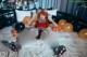 A woman laying on a bed surrounded by halloween decorations.