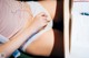 A pregnant woman laying on a bed with a pen in her hand.